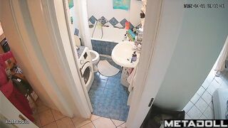 Brunette's sitting on the toilet in funny pajamas