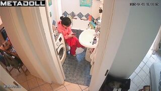 Brunette's sitting on the toilet in funny pajamas