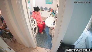 Brunette's sitting on the toilet in funny pajamas