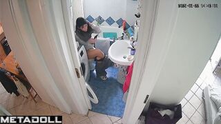 Brunette enjoys taking a break from her family in the toilet