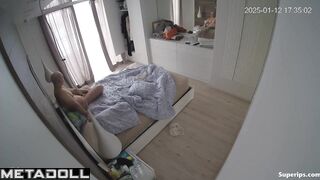 A blonde and her husband are looking at themselves naked in the mirror