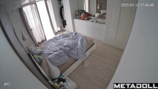 A blonde and her husband are looking at themselves naked in the mirror