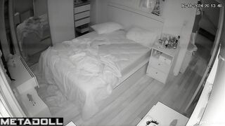 A cute, beautiful girl is lying in bed with her legs spread seductively