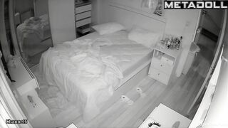 A cute, beautiful girl is lying in bed with her legs spread seductively