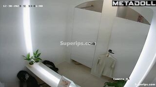 Cute Asian girls undress while trying on new clothes in the dressing room
