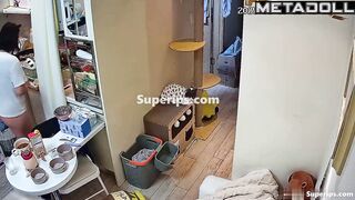 A chubby Asian girl walks around the apartment without panties