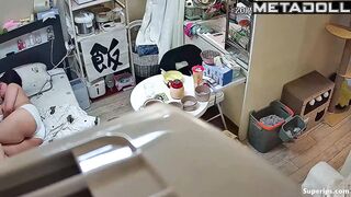 A chubby Asian girl walks around the apartment without panties