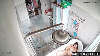 A chubby brunette caresses her hot pussy under the shower stream