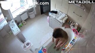 A skinny, cute little cutie pees before getting into the bathtub